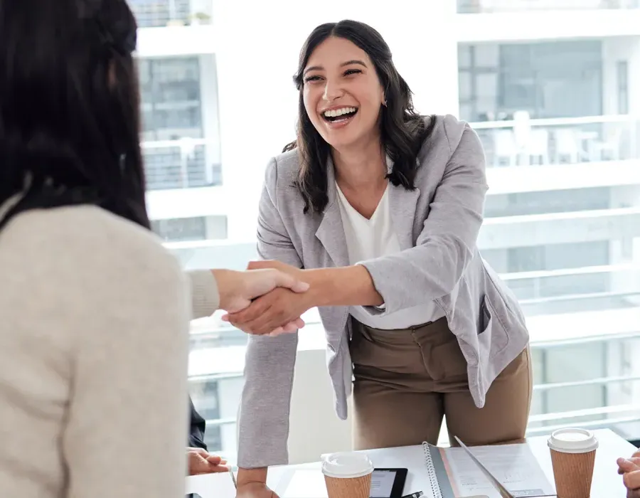 Human Resources Manager Smiling and Shaking Hands with Coworker